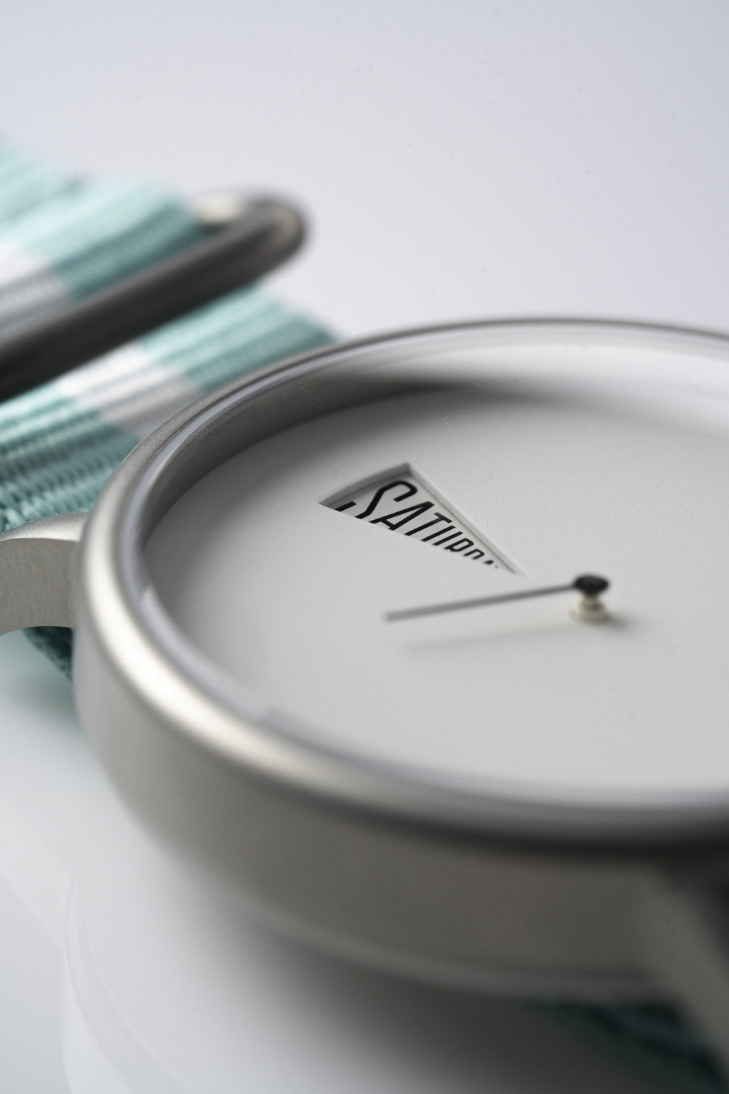 The Point White Daywatch — close-up of dial face showing SATURDAY on white dial