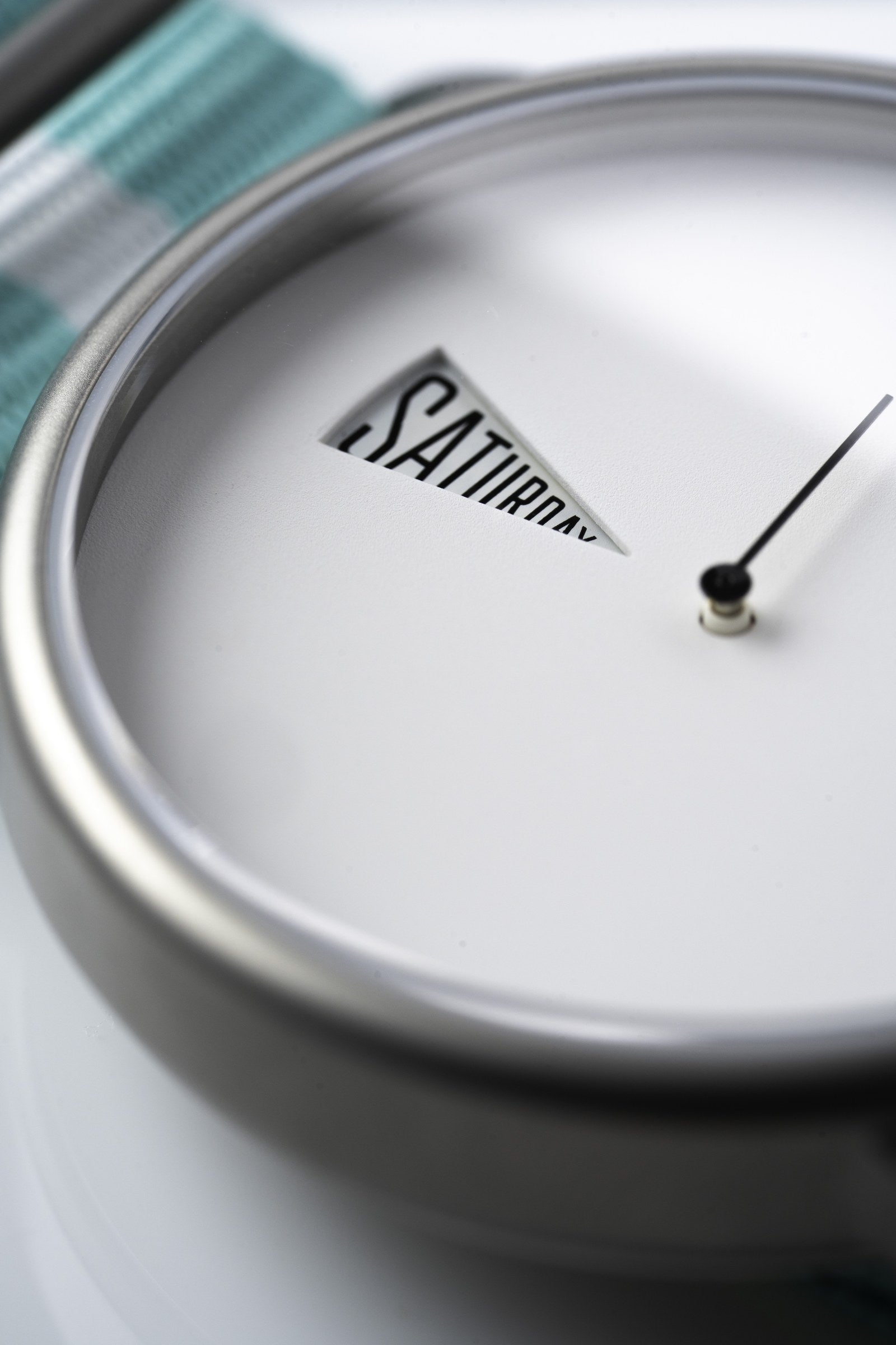 The Point White Daywatch — macro dial shot showing SATURDAY with ticking second hand