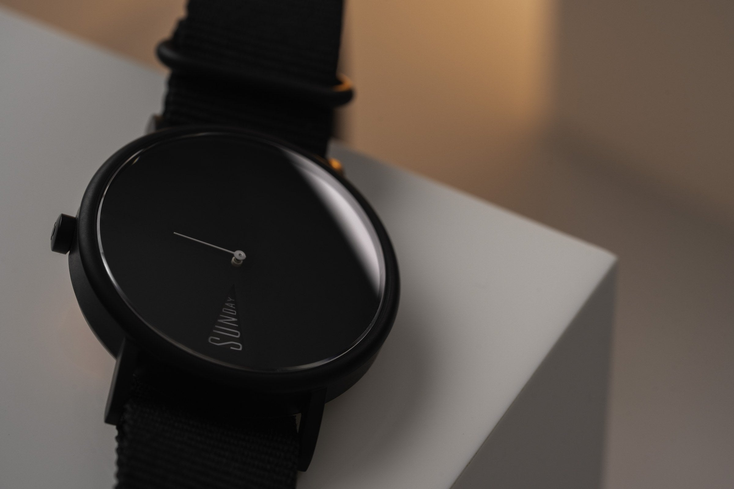The Point Black by Daywatch — hero studio shot showing all-black dial and case on geometric surface