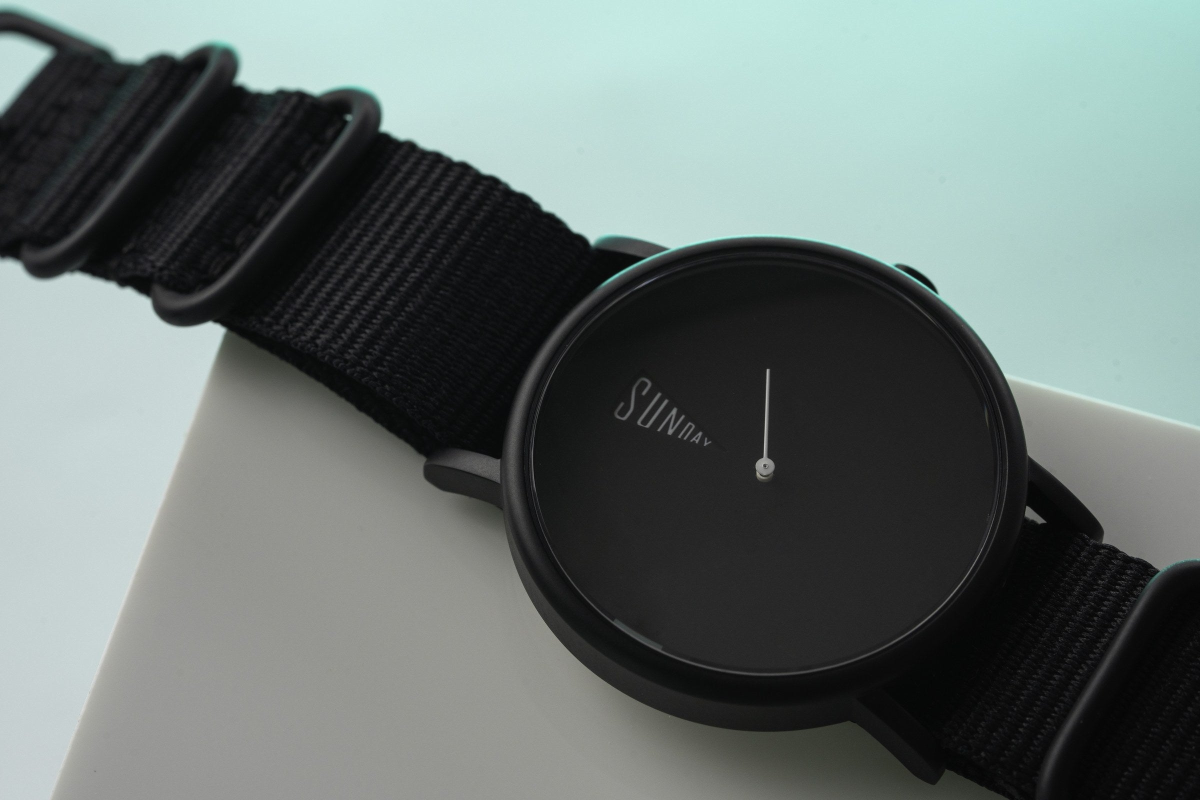 The Point Black Daywatch — dial face straight on showing SUNDAY text and second hand