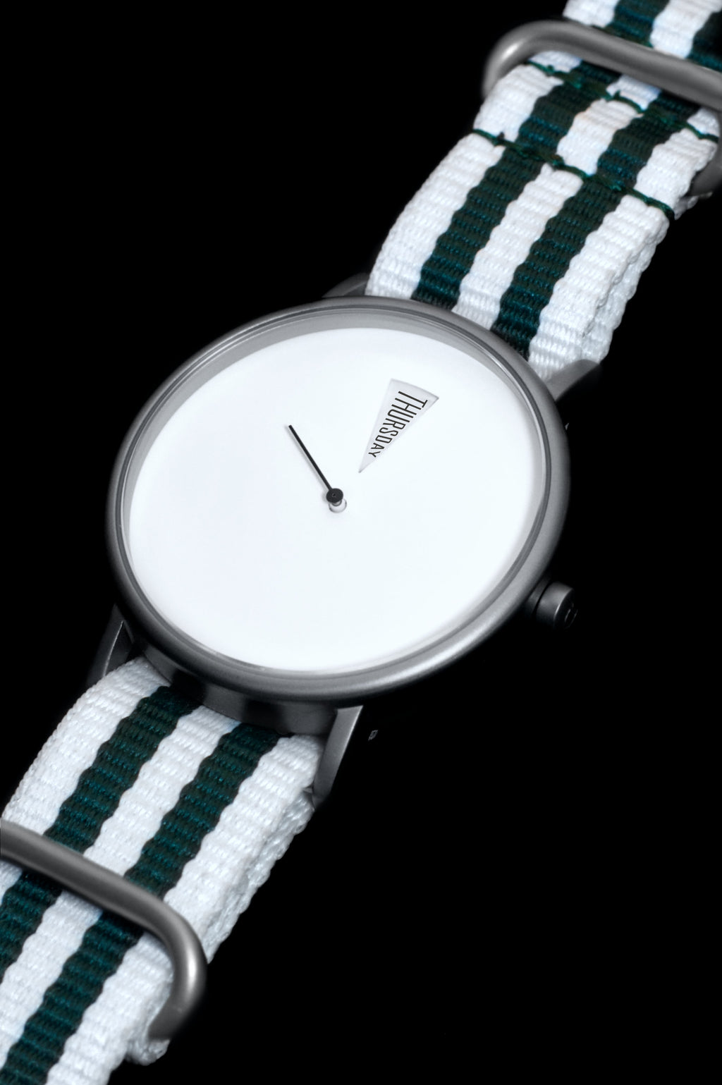 Detail shot of The Point White Daywatch — polished stainless steel case and domed sapphire crystal