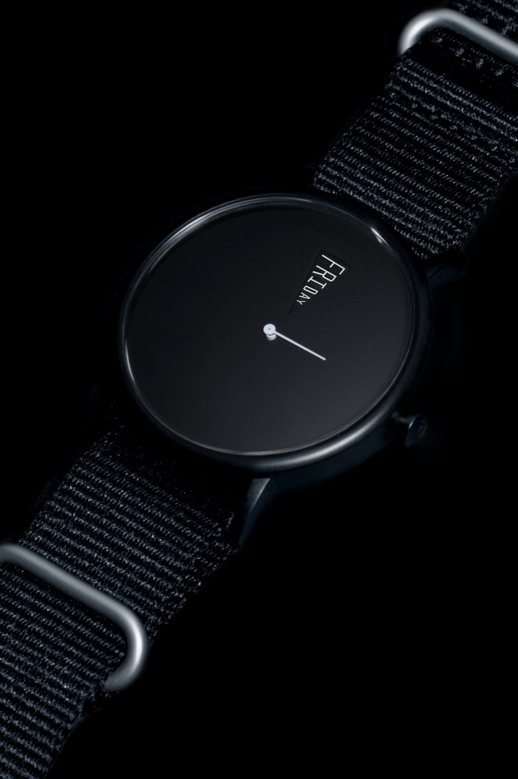 Detail shot of The Point Daywatch case — domed sapphire crystal glass and black ion plating